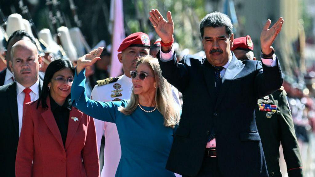 Venezuela's President Nicolas Maduro (R) and First Lady Cilia Flores wave next to Vice President Delcy Rodriguez (L) on arrival at the Capitolio - house of the National Assembly - for the presidential inauguration, in Caracas on January 10, 2025