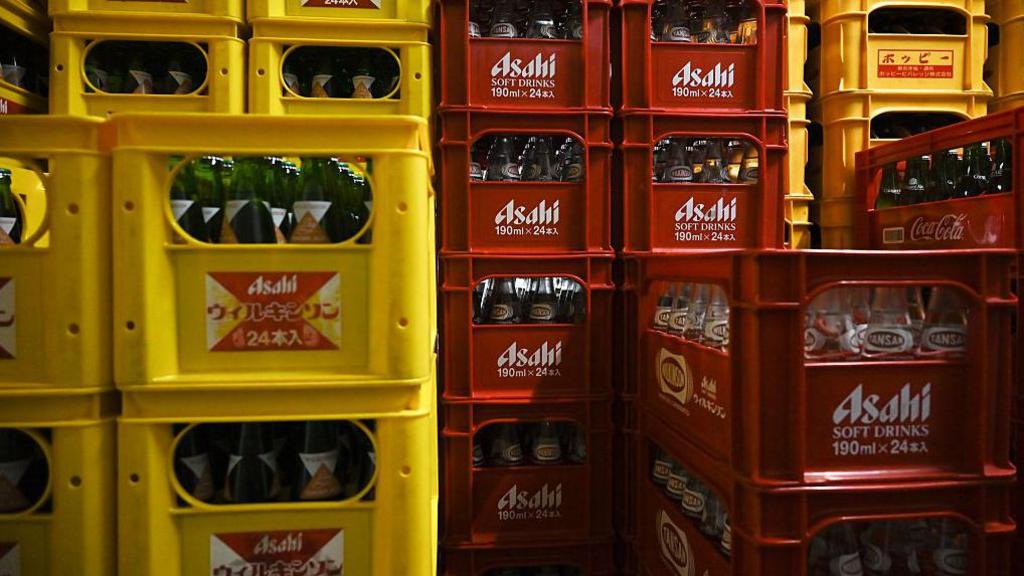 Bottles of Asahi carbonated water in red and yellow crates stored at a liquor store in Tokyo