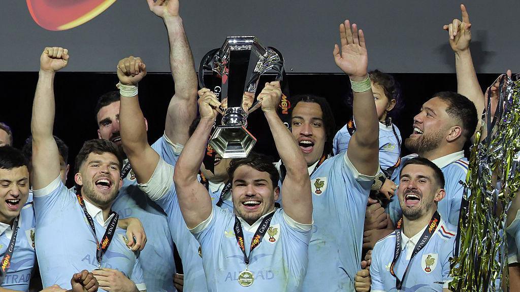 France celebrating with trophy after winning Six Nations.