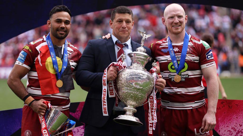 Bevan French, Matt Peet and Liam Farrell of Wigan Warriors celebrate winning the Challenge Cup