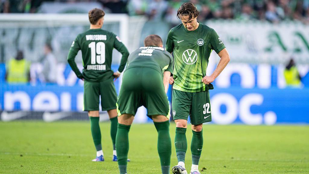 Wolfsburg players look upset as they lose 1-0 to Bayern Munich.