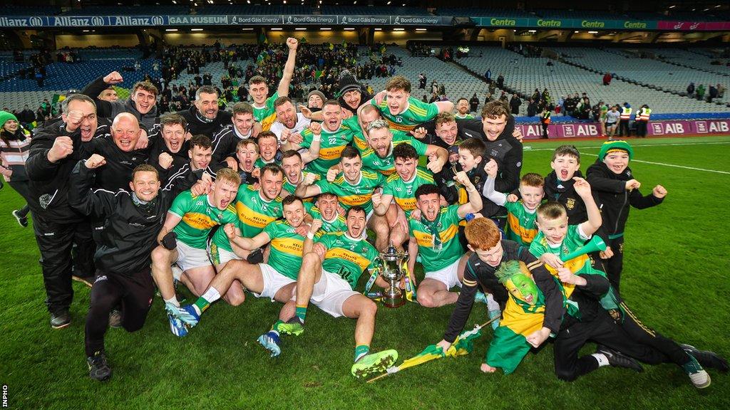 The Glen players pose with the Andy Merrigan Cup