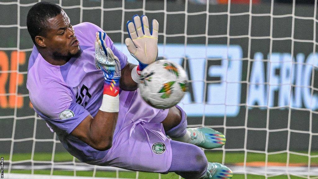 Stanley Nwabali saves a penalty for Nigeria against South Africa