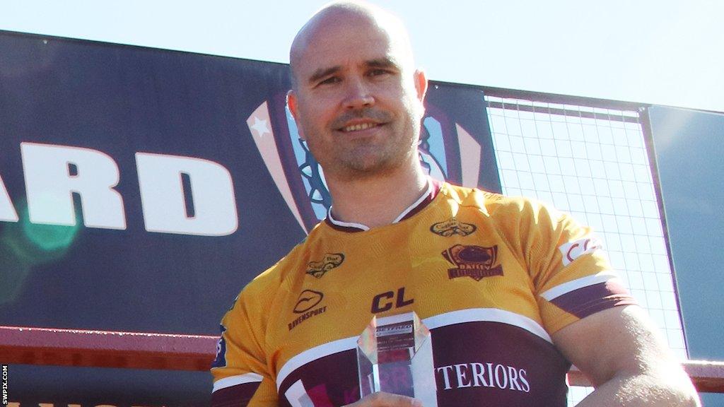 Craig Lingard holds his coach of the year award during his time at Batley