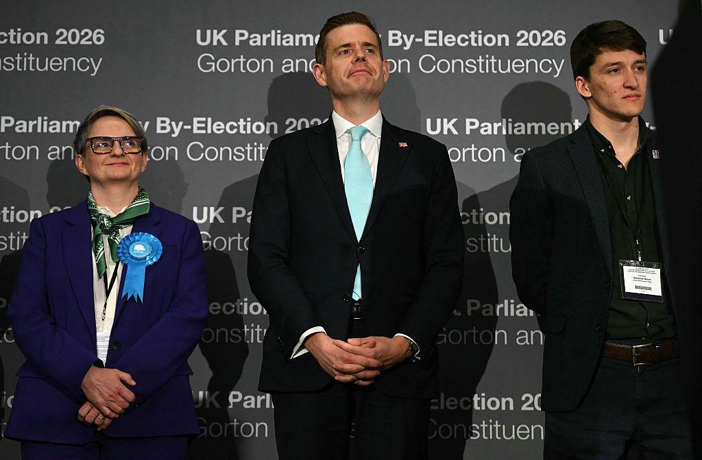Conservative party candidate Charlotte Cadden (L), Reform UK candidate Matt Goodwin (C) and Social Democratic Party candidate Sebastian Moore listen as Green Party candidate Hannah Spencer (unseen) gives her acceptance speech.