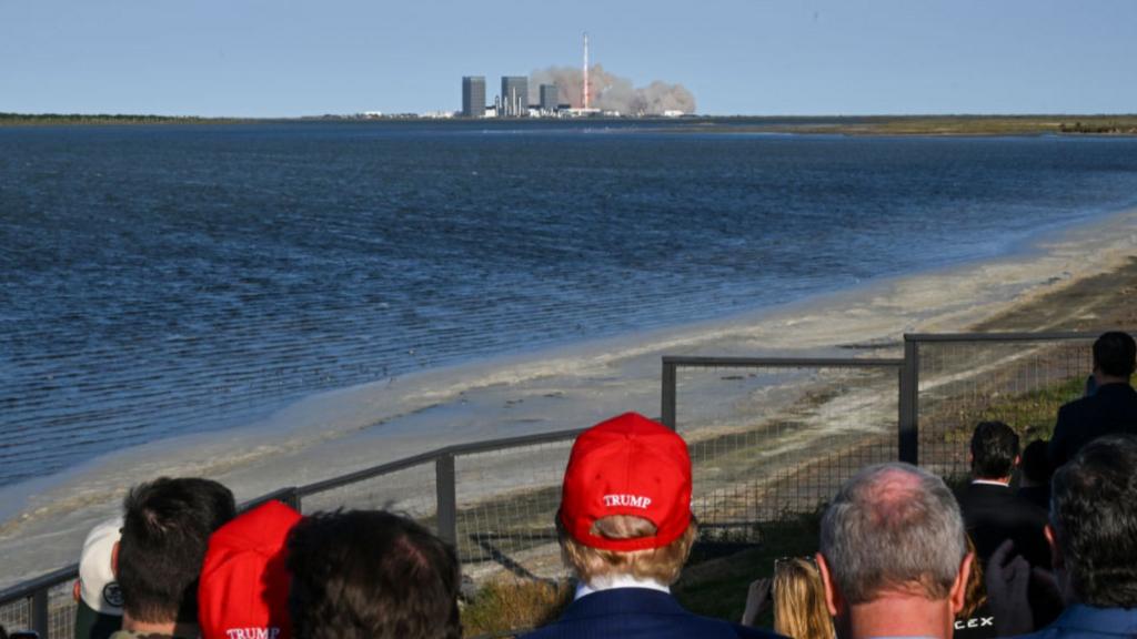 Trump watches on as SpaceX launches a rocket in the distance