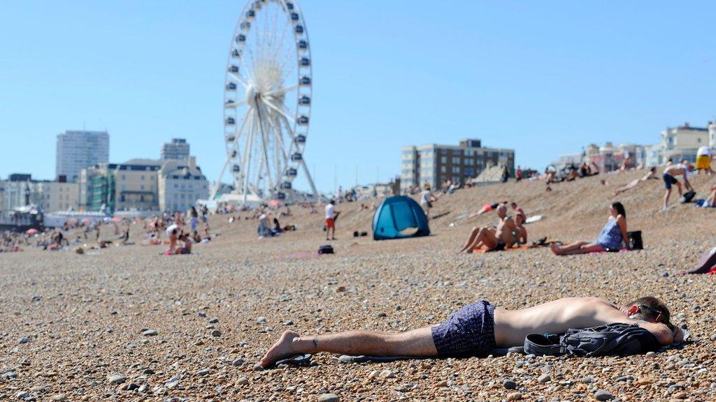 Sunbathers enjoy the hot weather on the beach in Brighton, East Sussex, as temperatures over 28C (83F) have been recorded in Surrey, making today the hottest day of the year so far.