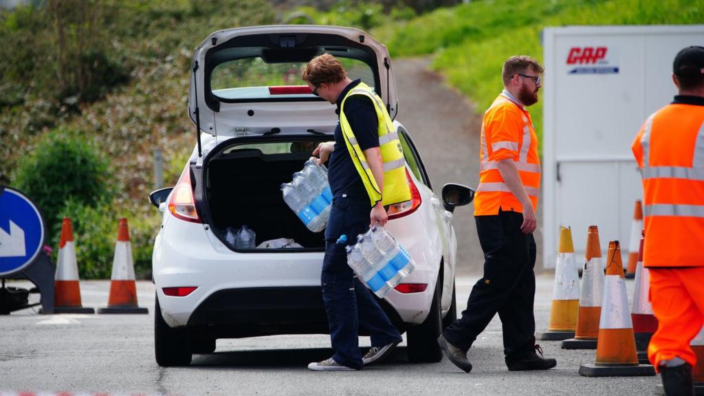 Workers handing out water