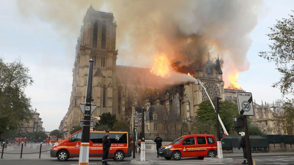 Flames and smoke are seen billowing from the roof at Notre-Dame Cathedral April 15, 2019 in Paris, France.