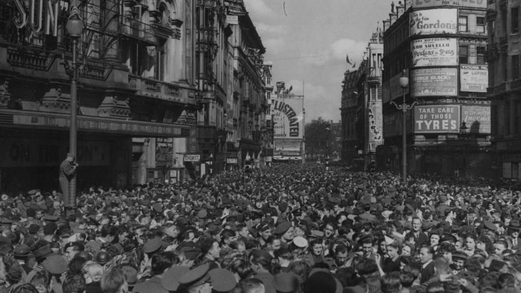 A huge crowd gathers in Piccadilly Circus in London to celebrate the news of Japan's surrender on 15 August 1945.