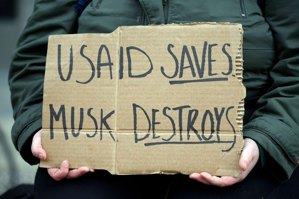 Sign says USAID Saves, Musk Destroys