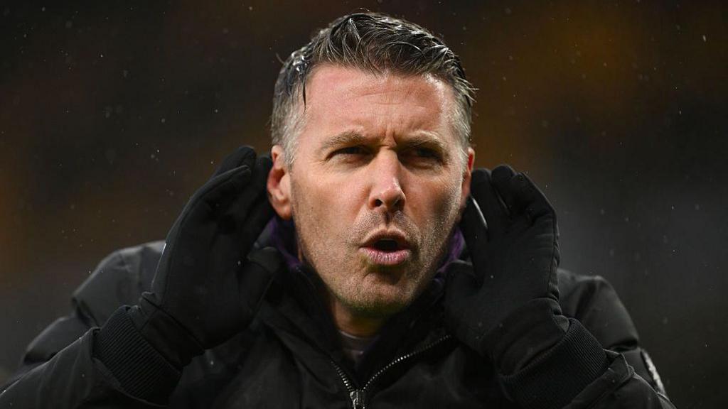 Rob Edwards gestures to the Molineux crowd during a Wolves game