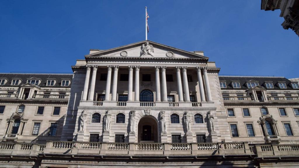 Bank of England is seen in daylight. It is a large white building with columns.