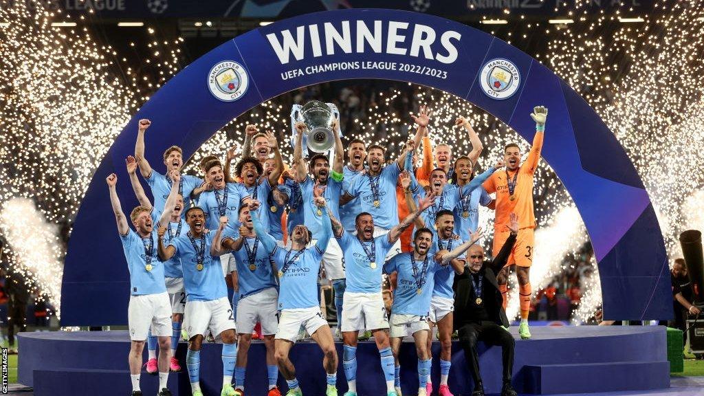 Manchester City players celebrate as then captain Ilkay Gundogan lifts the Champions League trophy