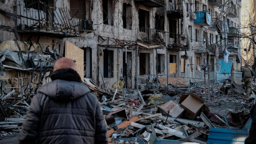  A person looks at damaged buildings two days after a Russian shelling in Dobropillya