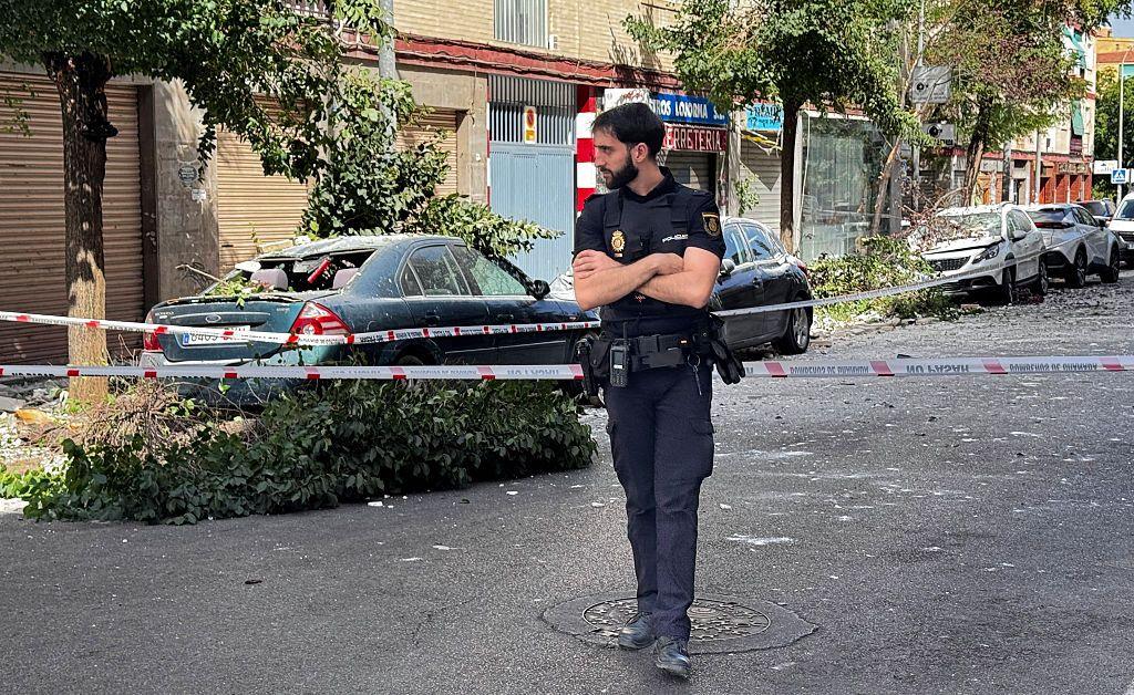 A policeman stands at a cordoned off street near damaged vehicles following an earthquake in Granada, southern Spain. Photo: 18 August 2026
