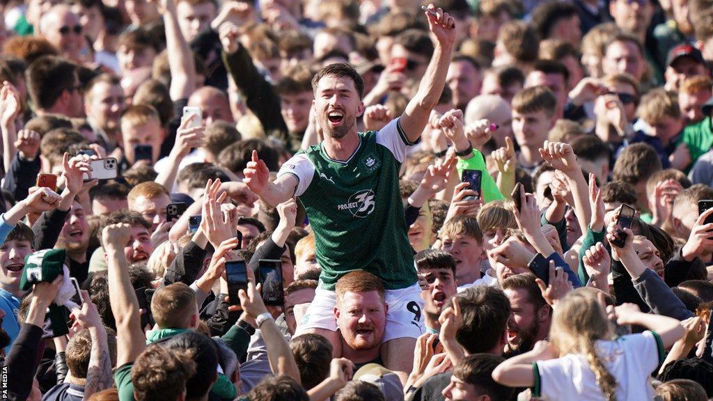 Ryan Hardie is lifted up by Argyle fans