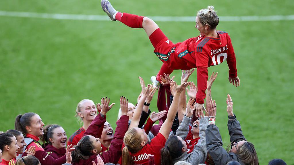 Jess Fishlock is thrown into the air by her team-mates at full time 