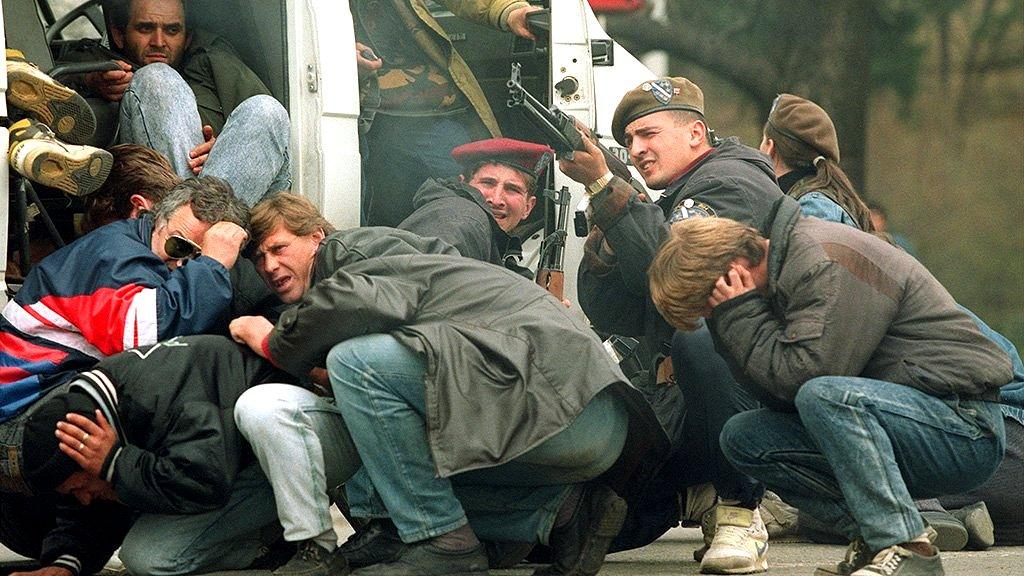 A Bosnian special forces soldier and civilians come under fire from Serbian snipers, Sarajevo, 6 April 1992