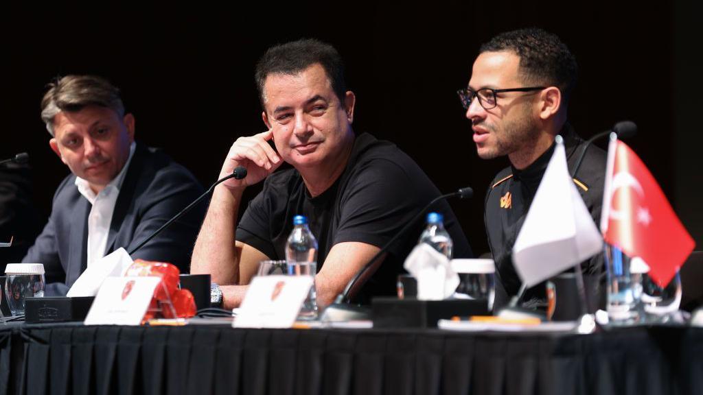 Liam Rosenior speaks during a Hull City press conference in Antalya, Turkey in March 2024. Hull City's owner Acun Ilicali and vice president Tan Kesler are sat alongside him. 