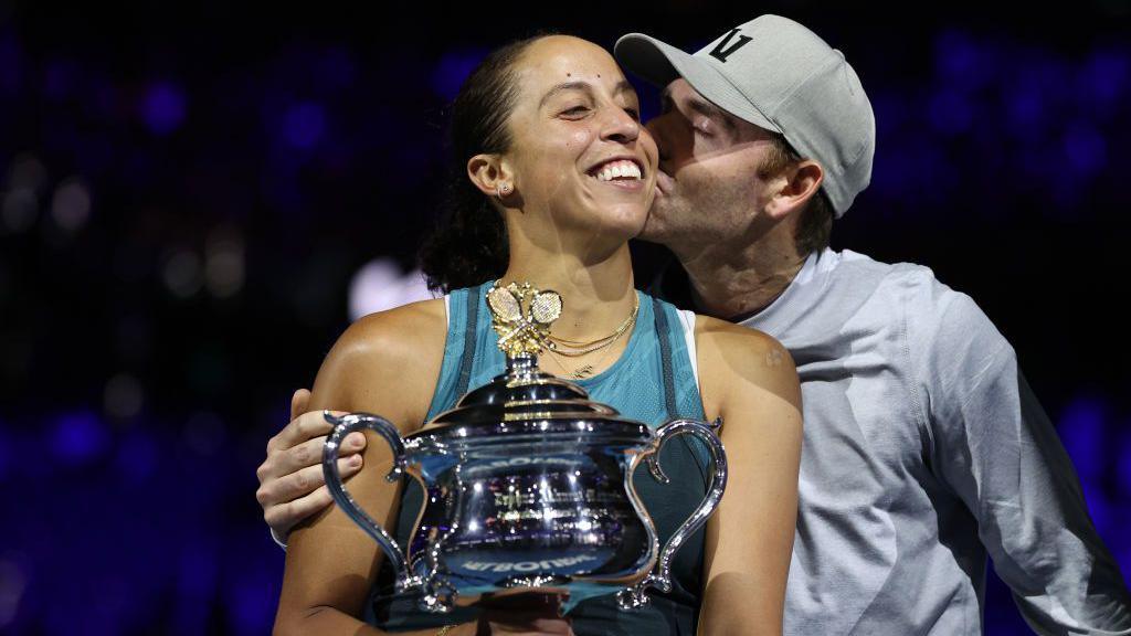 Madison Keys of the United States is kissed by her coach and husband Bjorn Fratangelo