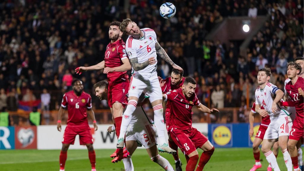 Joe Rodon rises to challenge as Nair Tyknizyan heads the ball into his own net