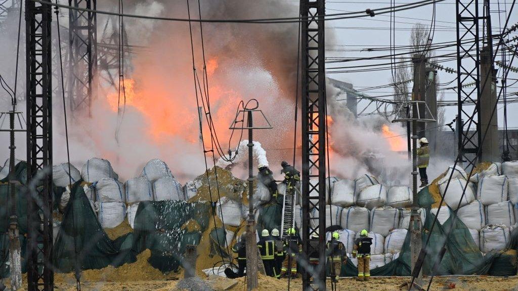 Firefighters extinguish a fire at a power station after a missile attack in Kharkiv, on March 22, 2024