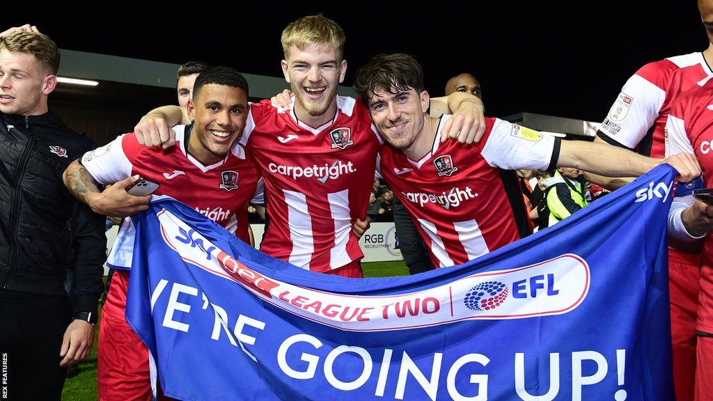 Josh Coley, Kieran Phillips and Josh Key celebrate promotion in April 2022