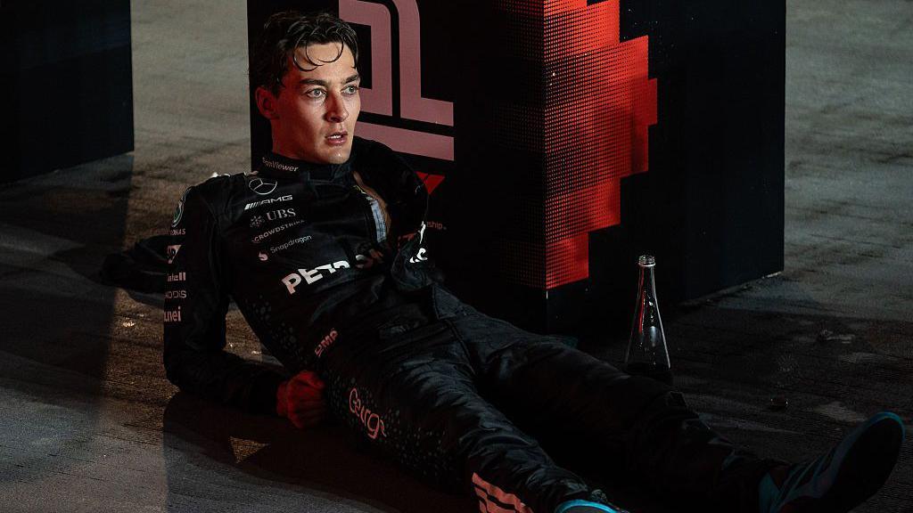 George Russell lying down and looking exhausted after the Singapore Grand Prix