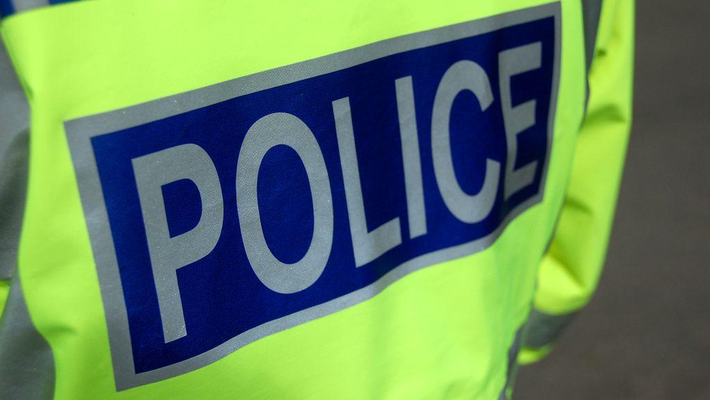 Hi vis jacket that says police
