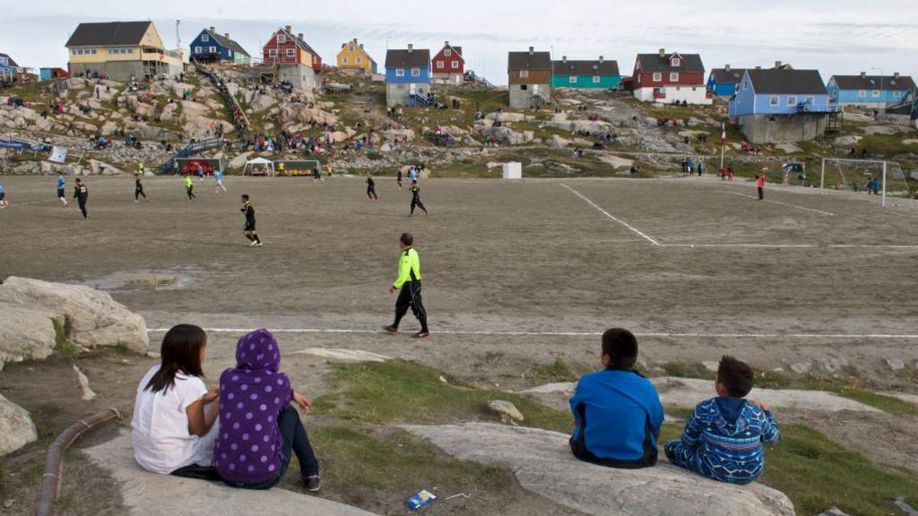 A football match on a gravel pitch in Greenland