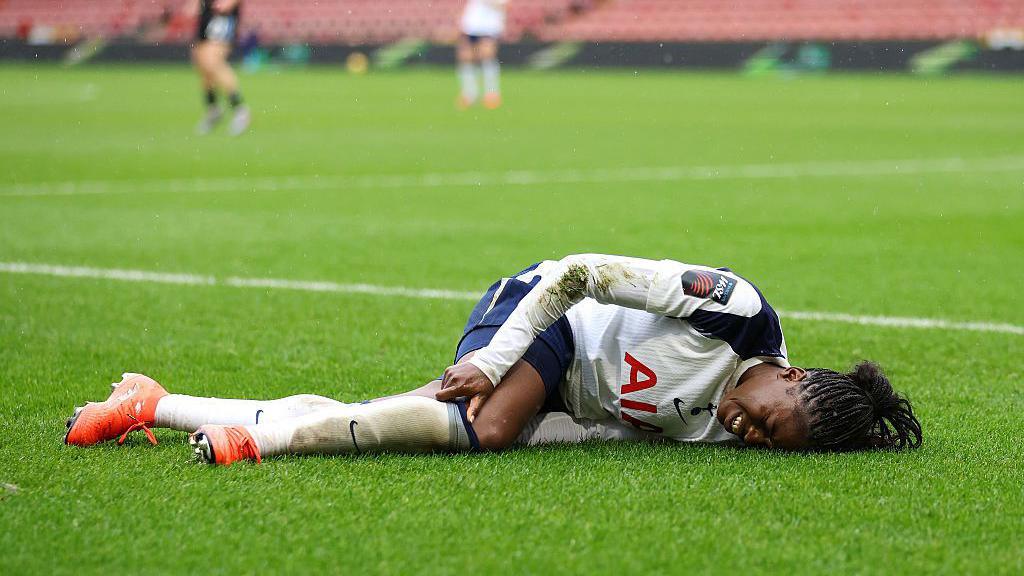 Jess Naz lies in pain after suffering an ACL injury