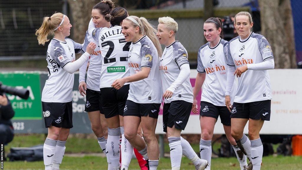 Swansea City players celebrate after scoring against Wrexham