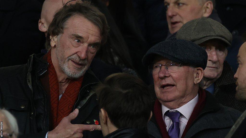 Sir Jim Ratcliffe speaking to Sir Alex Ferguson at a Manchester United game