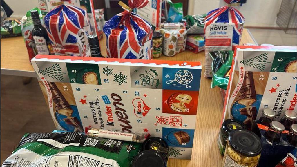 Food, including loaves of bread and advent calendars, on a table 