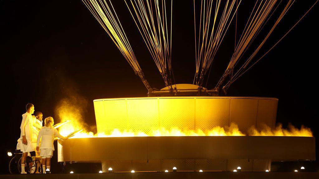 French Paralympians Charles Antoine Kouakou, Fabien Lamirault, Elodie Lorandi, Nantenin Keita and Alexis Hanquinquant light the Paralympic cauldron 