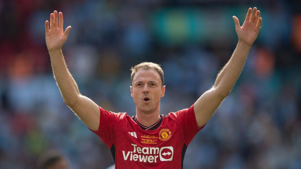 Jonny Evans celebrates winning the FA Cup 