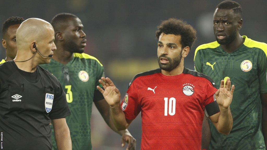 Mohamed Salah talks to the referee while in action for Egypt during the 2021 Africa Cup of Nations final against Senegal