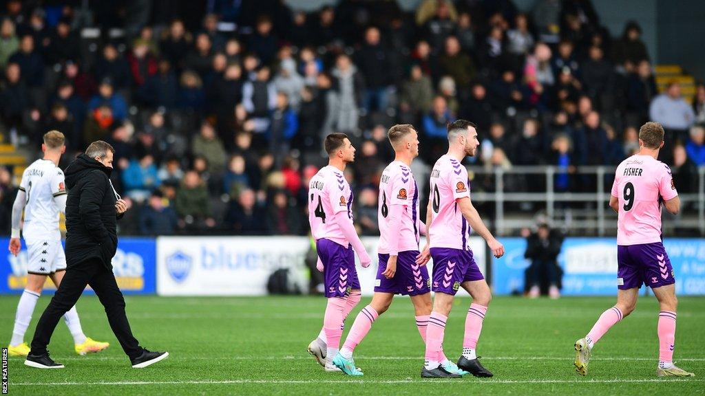 Yeovil players leave the pitch following the medical emergency