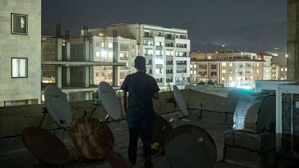 A man stands on a roof