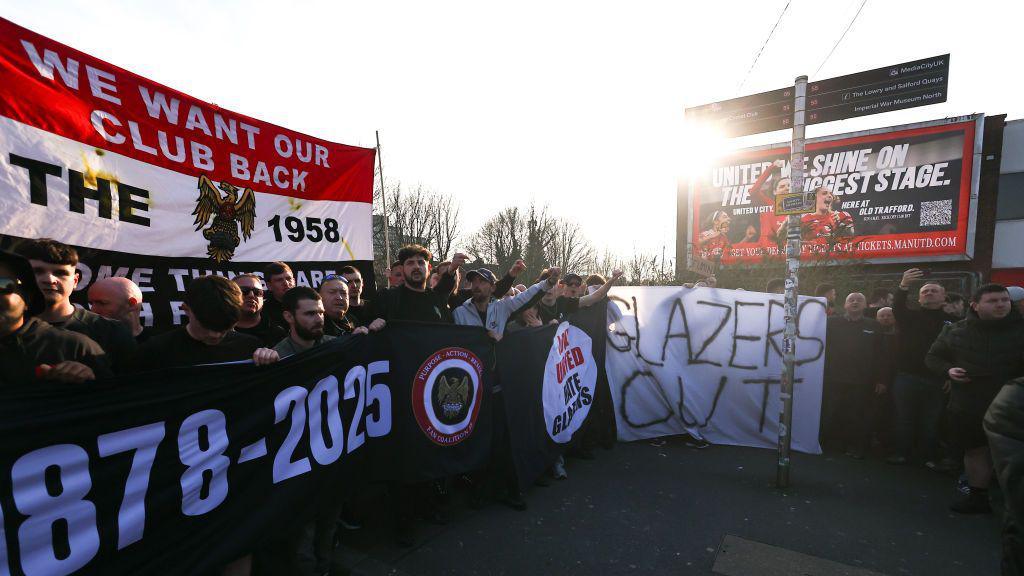 Fans of Manchester United march and protest against the club's ownership, The Glazers and Sir Jim Ratcliffe, ahead of the Premier League match between Manchester United and Arsenal at Old Trafford on 9 March.