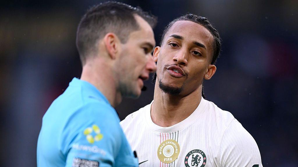 Joao Pedro of Chelsea speaks to referee Jarred Gillett during the Premier League match between Wolverhampton Wanderers and Chelsea