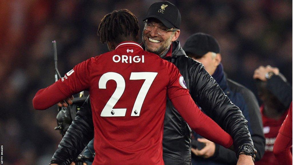 Divock Origi and Jurgen Klopp embrace