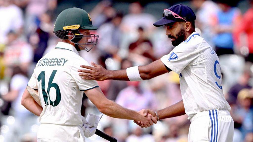 Nathan McSweeney (left) and Jasprit Bumrah shake hands after Australia win the second Test at Adelaide 