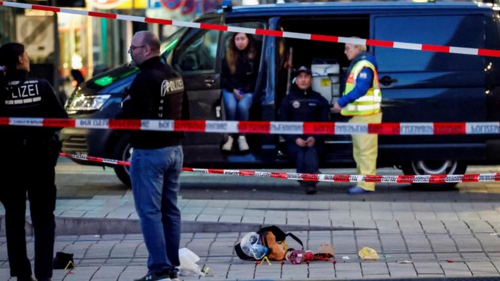 Belongings lie on the ground at the site where a car drove into a crowd, in Mannheim