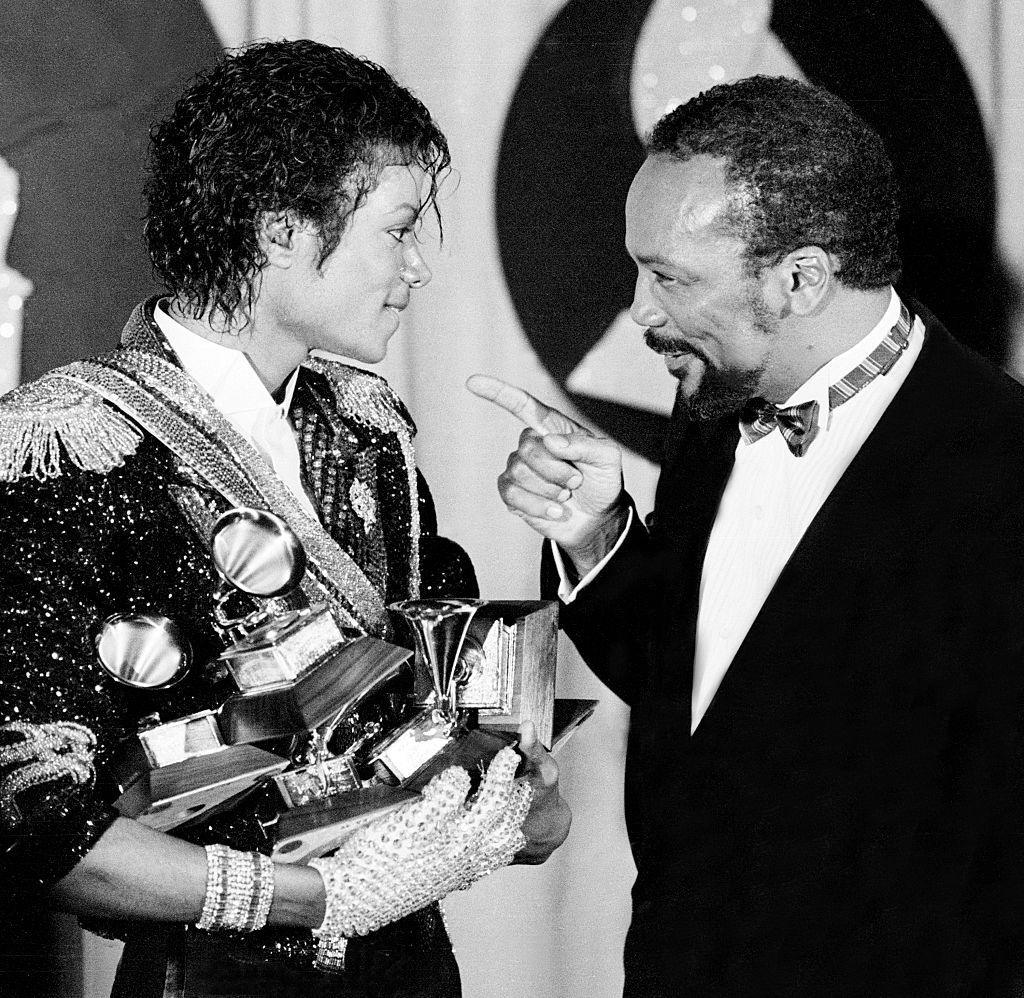 Quincy Jones and Michael Jackson at the 1984 Grammy Awards - Jones is pointing affectionately at Jackson, who is holding several Grammys in his arms