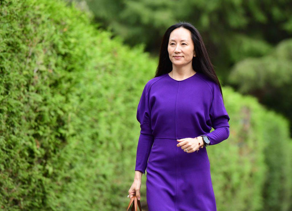 Meng Wanzhou in a purple dress leaves her home in Vancouver to attend her last extradition hearing in August 2021.