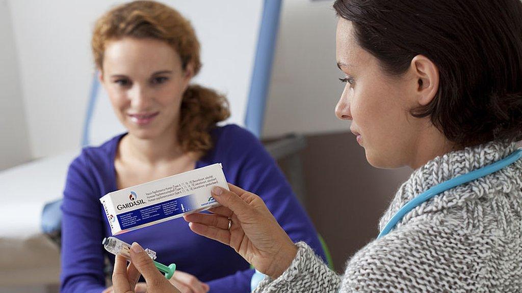 Woman looking at a box Gardasil