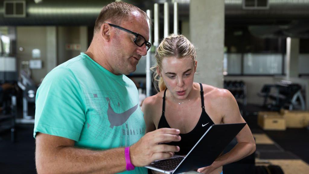 Trevor Painter and Keely Hodgkinson discuss training data displayed on a laptop