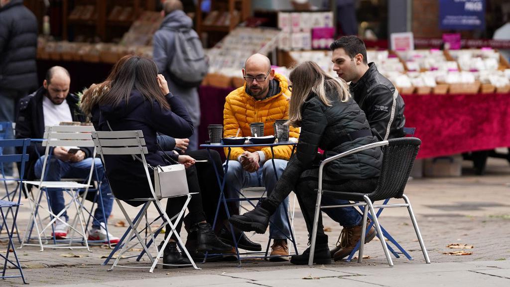 People sat on the pavement